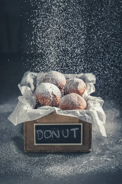 Falling sugar on sweet donuts balls hot and freshly baked — Stock Photo, Image