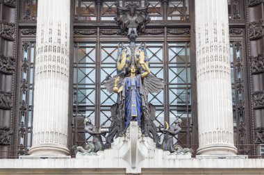 Statue and clock outside Selfridge's in London, UK clipart
