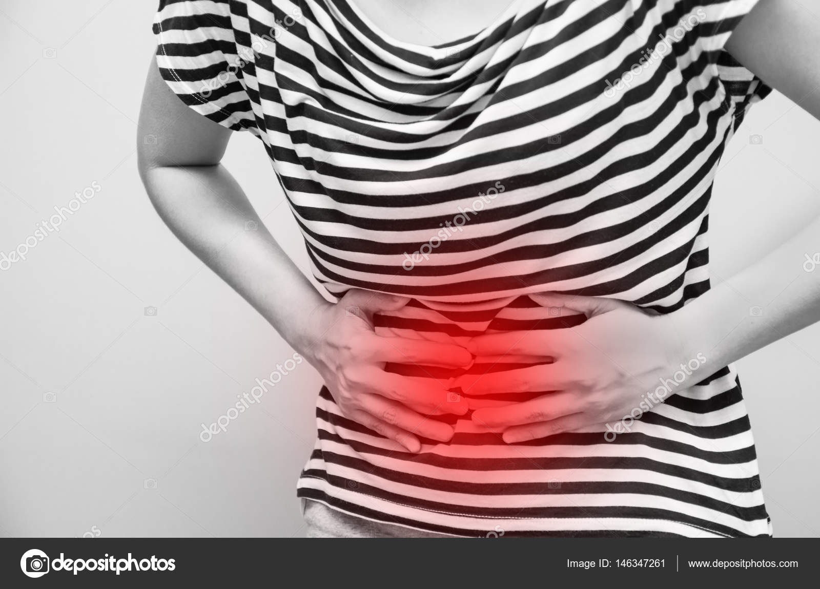 Young woman having abdominal pain, upset stomach or menstrual cramps ⬇