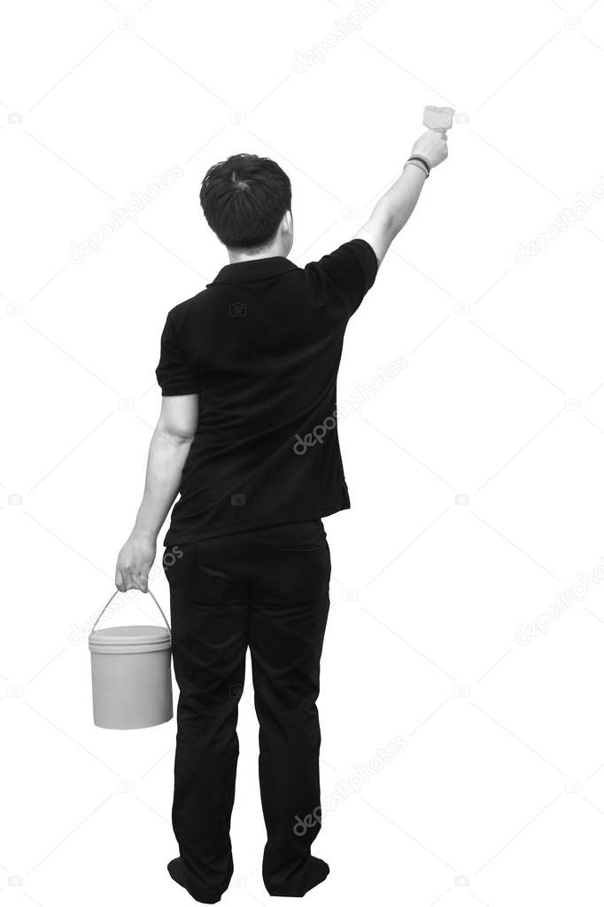Rear view of Asian painter painting the wall, with paint brush and bucket isolated on white, black and white tone
