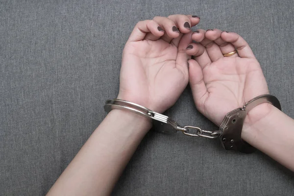 Woman\'s hands in shackles, Sex Toy Handcuffs or arrest prisoner