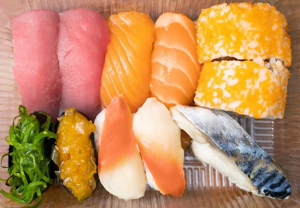 Variety of sushi in plastic box for delivery service. Food delivery concept. Japanese traditional food