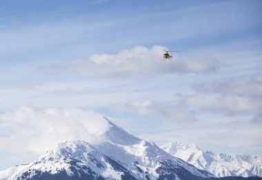 Helicopter over mountains clipart
