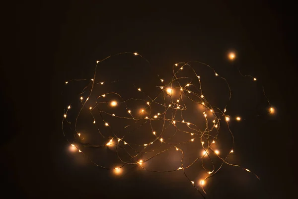 Fairy lights at night on black — Stock Photo, Image