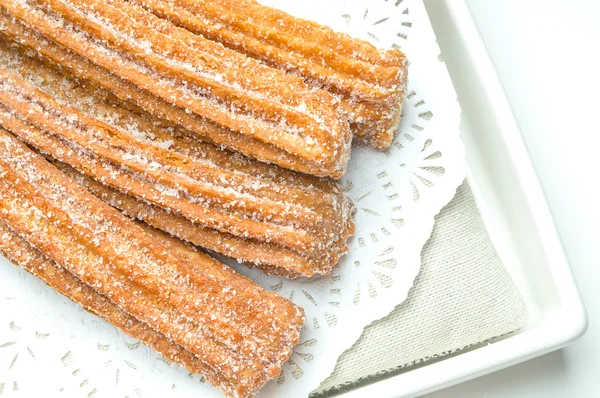 Churros on a decorated plate — Stock Photo, Image