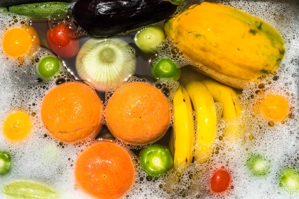 Fruit and vegetables washing in soapy water for coronavirus disinfection.