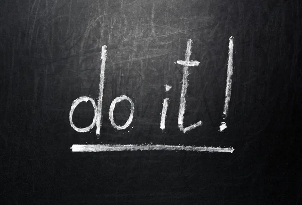 Handwritten motivation words - Do it! on the school chalkboard