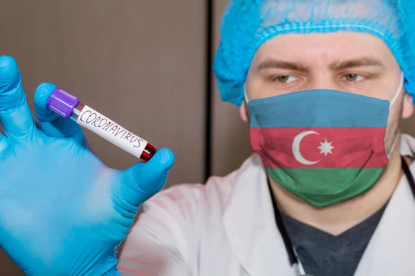 Doctor wearing mask with flag Azerbaijan holding a blood test for Coronavirus