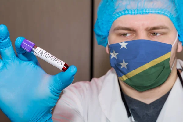 Doctor wearing mask with flag Solomon islands holding a blood test Coronavirus