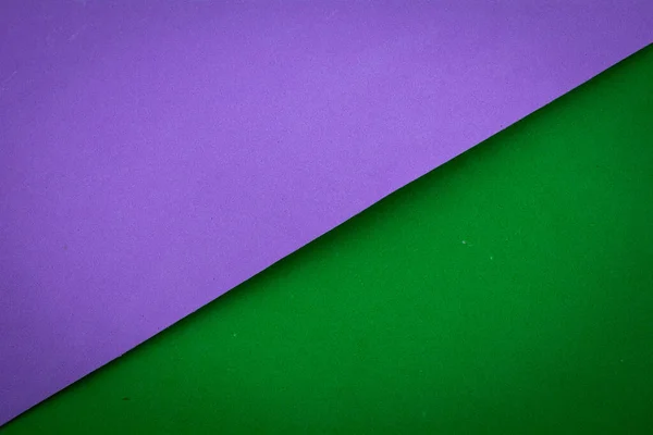 Violet and green pastel color paper geometric flat lay background