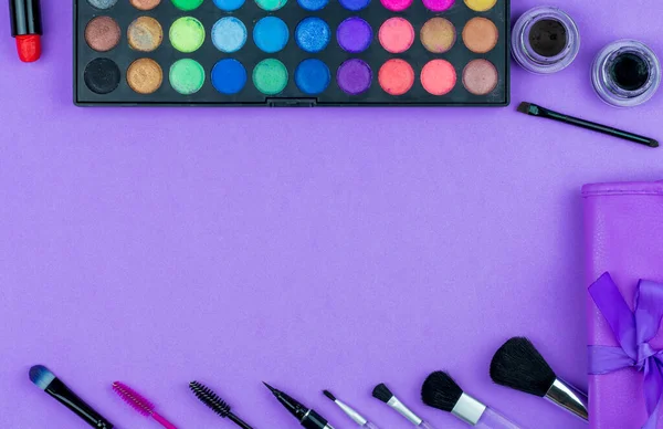 beauty flat lay. makeup tools on a purple background. frame