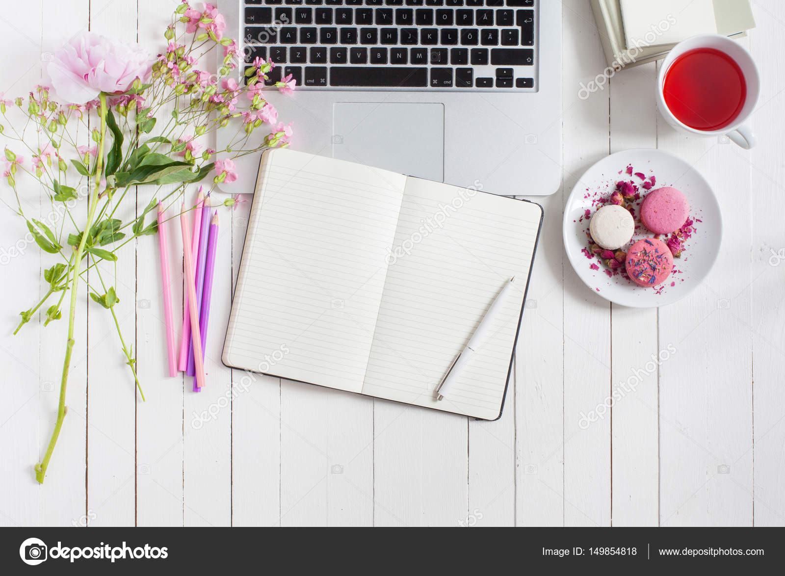 Feminine flat lay workspace with laptop, cup of tea