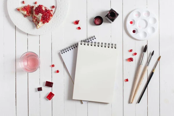 Mock up. Artist workspace on white wooden table: red watercolor, paintbrushes and water — Stock Photo, Image