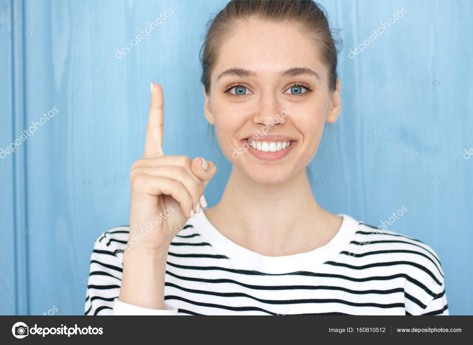 I have a great idea! Photo of energetic cute teenage smiling girl in  striped t-shirt pointing her finger up in eureka sign, having great  innovative thought, understanding solution she has just got. —, image size:1600x1167