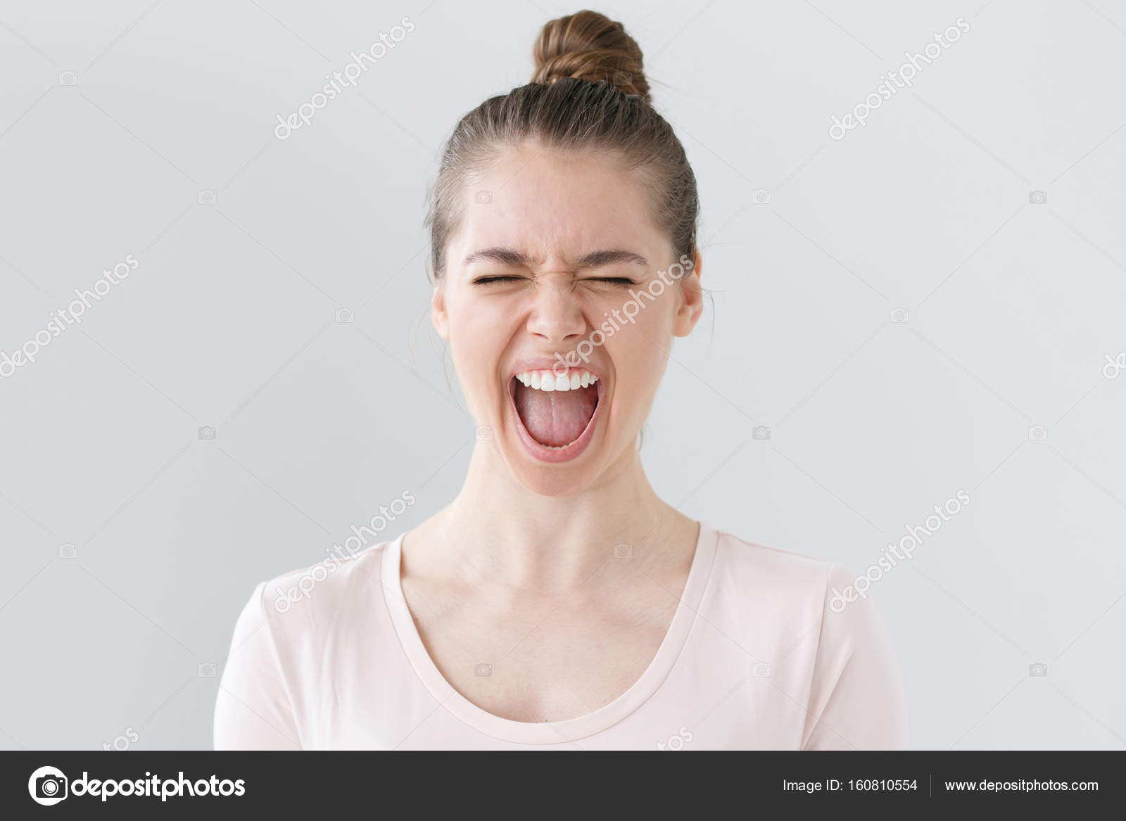 girl eyes closed and open the mouth Indoor photo of young beautiful woman isolated on grey background screaming  loudly with emotional expression on