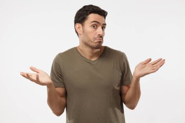 Bilmiyorum. Sanki o ne yapacağını bilmez genç adam, zararına olan gri arka plan üzerinde izole çaresiz jest kol ve el, ağız ile gösterilen kavisli