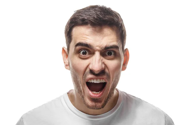 Closeup shot of furious shouting man standing isolated against white backgroung and screaming desperately. What have you done concept — Stock Photo, Image
