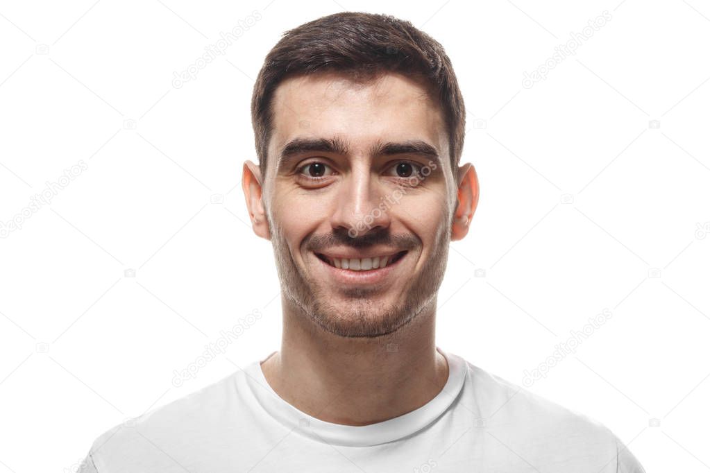 Close up headshot portrait of smiling handsome man in white t-shirt isolated 