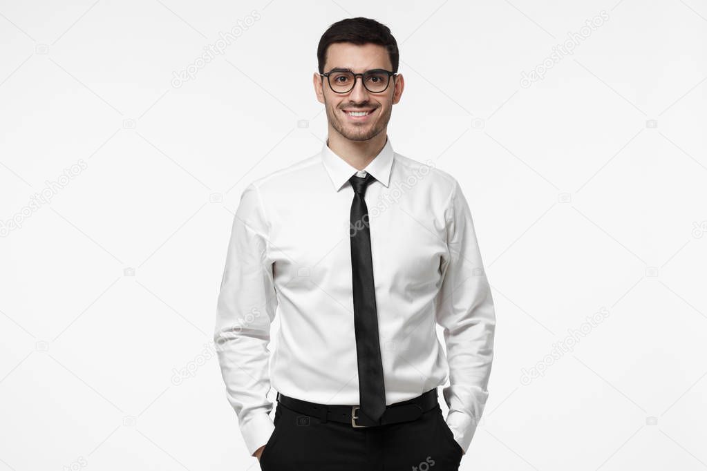 Portrait of young salesman, happy positive manager, isolated on grey background 
