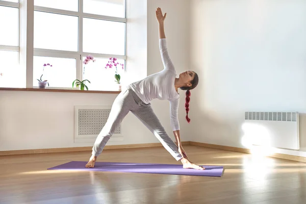 the young attractive sport girl dressed in light sports clothing