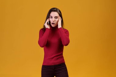 Genç bir kadın telefonla konuşuyor, haberlerde ona bir şok koy. Genç uzman uzakta görünüyor