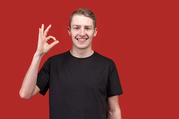 Confident young smiling man showing thumbs up OK sign and wide teeth smiles. The concept of success, joy, serenity. — Stock Photo, Image