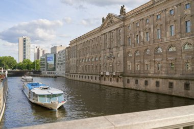 Yellow tourist ship sails along the Shree river.