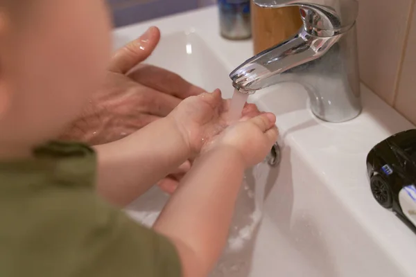 Hands of child and adult near sink. Wash hands — Stock Photo, Image
