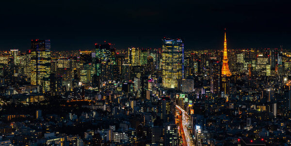A picture of the Tokyo cityscape, showing the Tokyo Tower, at night.