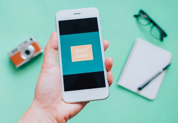 Hand holding smartphone with 2017 on screen — Stock Photo, Image