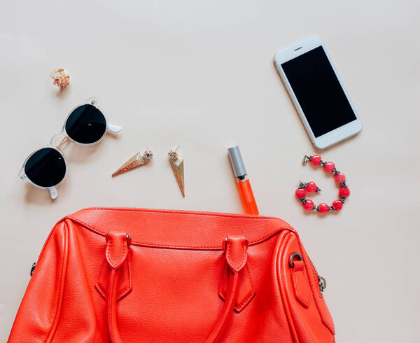 Flat lay of red leather woman bag