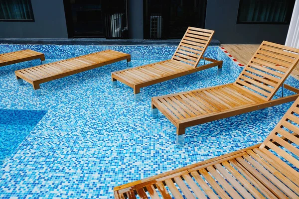 Wooden benches on swimming pool — Stock Photo, Image