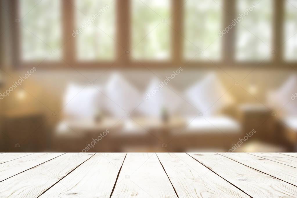 Empty wood table top on blur abstract of interior in cafe or living room, for montage product display