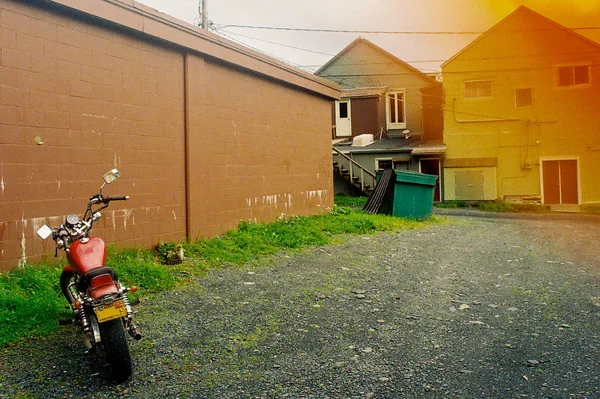 Motorbike Parked on Gravel Backroad with Film Discoloration