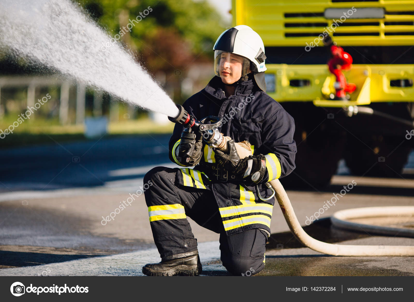 Fireman spilling water in combustion zone Stock Photo by ©VAKSMANV101 Fireman spilling water in combustion zone Stock Photo by ©VAKSMANV101