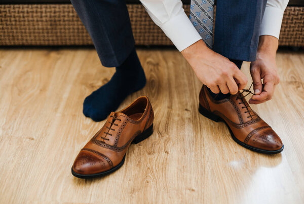 man dressing up with classic shoes