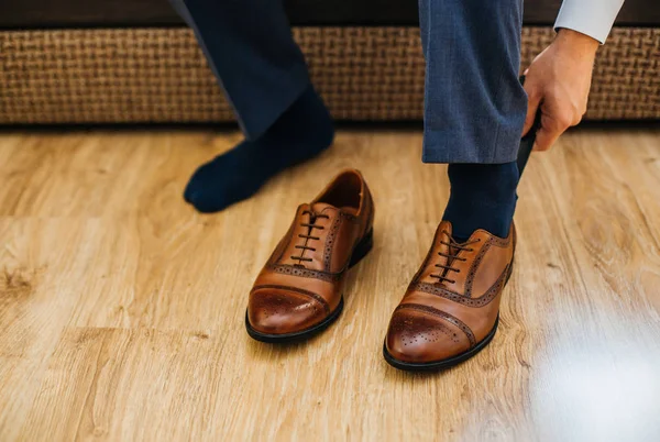 man dressing up with classic shoes