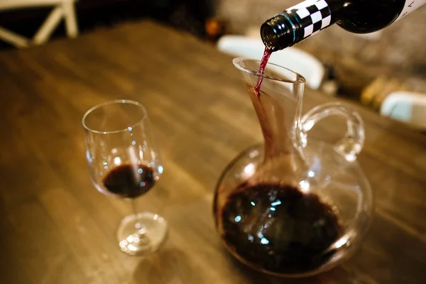 wine pouring into jar