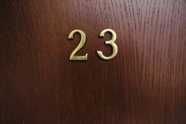 Golden numbers on wooden door — Stock Photo, Image