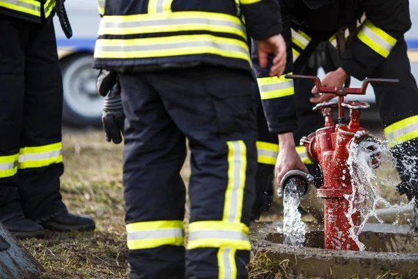 Firefighters fighting fire during training — Stock Photo, Image