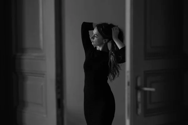 Beautiful brunette woman in black dress — Stock Photo, Image