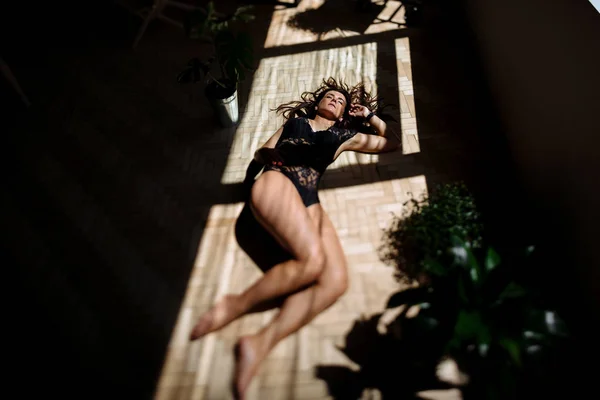 Young woman  laying on wooden floor — Stock Photo, Image