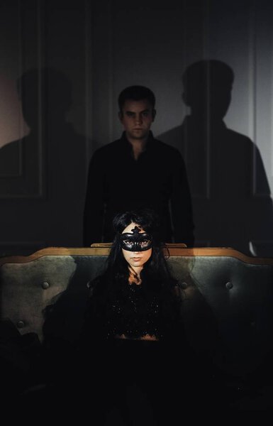 woman  with  theatrical mask and handsome man