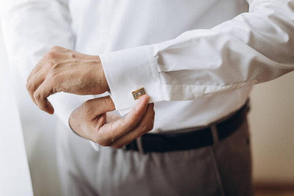 Dressing groom and preparing for ceremony 