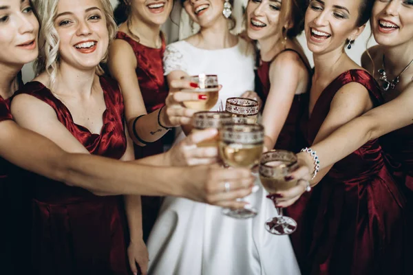 bridesmaids and bride toasting with champagne.