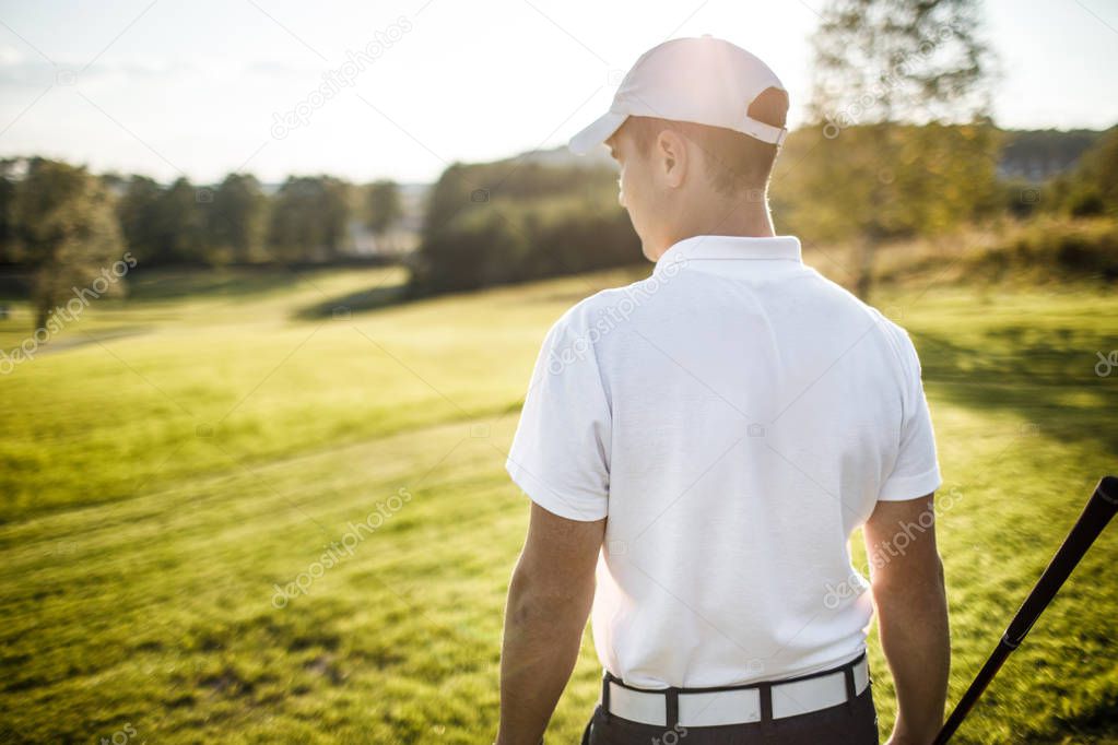 Golf player  on course during summer game golfing