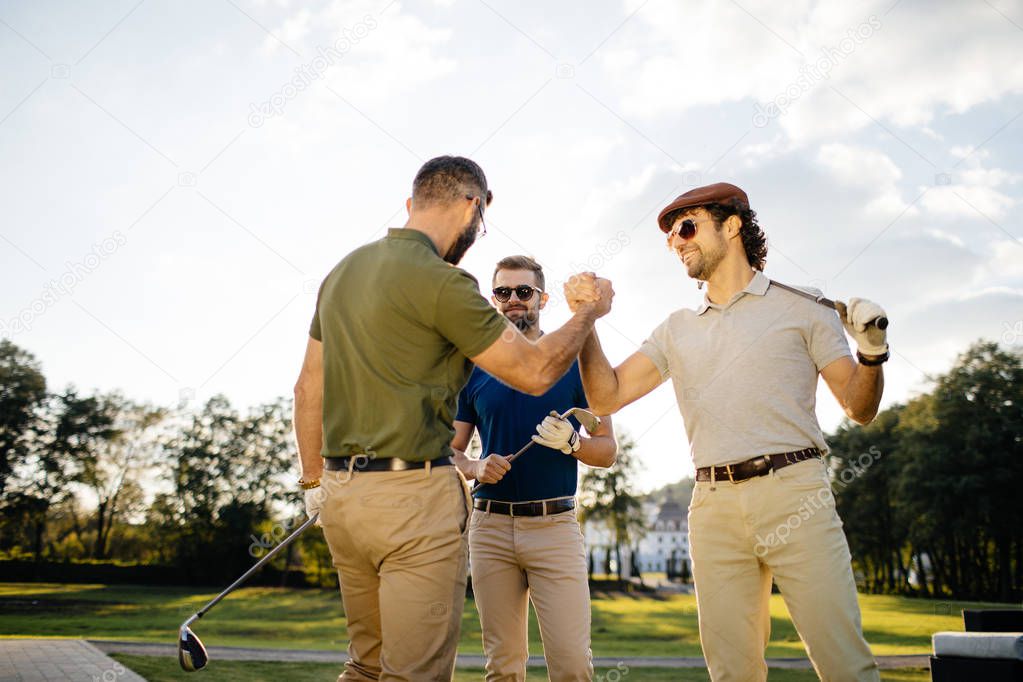 friends spending time on golf course