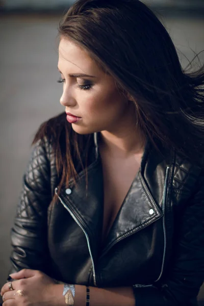 Beautiful young  woman in black jacket posing
