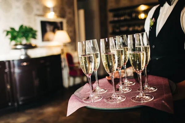 Garçom traz copos de champanhe — Fotografia de Stock