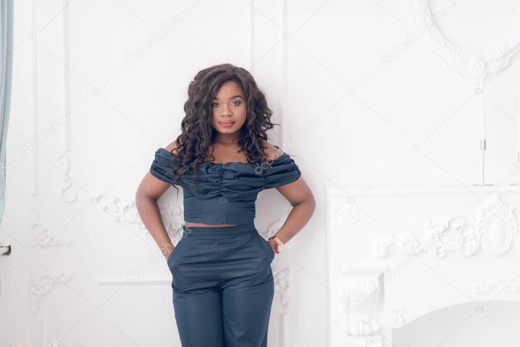 Beautiful young  African American woman in jumpsuit posing in studio